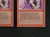 two cards that have a picture of a woman holding a sword