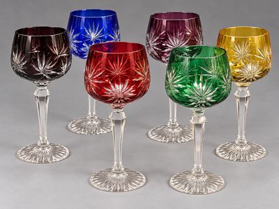 several different colored wine glasses sitting on top of each other