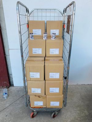 a cart full of boxes sitting on top of a cement floor