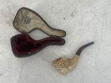 a pipe and a pipe holder sitting on the ground