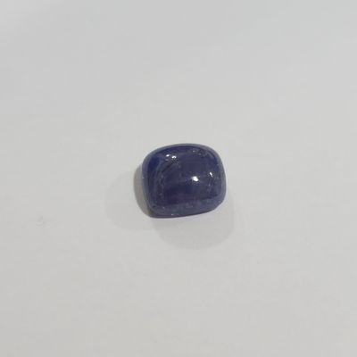 a close up of a blue stone on a white surface