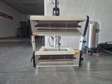 a heater that is sitting on a cart in a garage