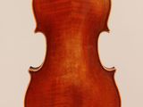 an old violin hanging from a string on a white background