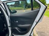the open door of a car with the driver ' s seat down