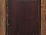 an old wooden frame with a black and brown painting on it