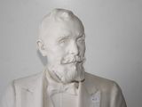 a statue of a man with a beard and a bow tie