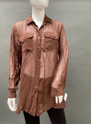 an image of a mannequin wearing a brown shirt and black leggings