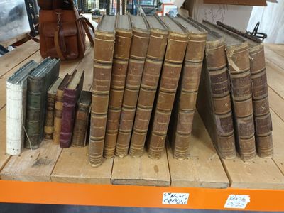 a lot of old books on a table in a store