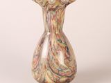 a multicolored vase sitting on a white surface