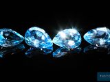 a group of three blue diamonds on a black background