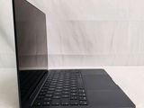 a black laptop with a black keyboard on a white surface