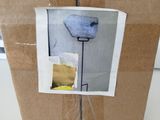 a cardboard box with a picture of a lamp inside of it