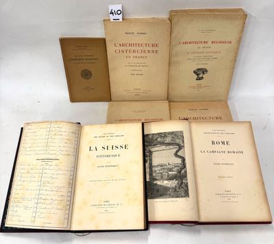 several old books sitting on top of each other on top of a table