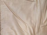a piece of cloth on a bed with a pillow on top of it