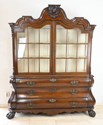 an old wooden china cabinet with glass doors and drawers on casteors