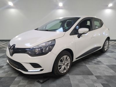 a white car is parked in a room with a checkered floor