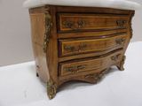 a marble top chest of drawers with a marble top