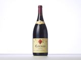 a bottle of red wine sitting on top of a table