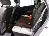 the back seats of a car with a red object in the back