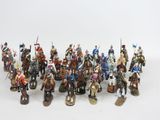 a lot of figurines that are on a white surface