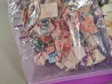 a bag full of stamps sitting on top of a table