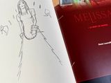 a book with a drawing of a woman in a dress