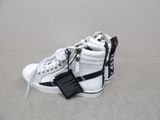 white and black high top sneakers with a tag on the side