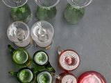many different colored glassware on the table