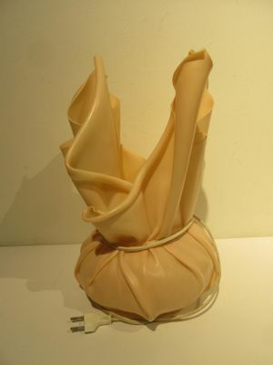 a sculpture of a vase on a white table