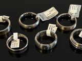 six different types of rings with tags on them on a table