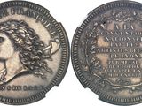 gros plan d'une pièce de monnaie sur laquelle figure un visage de femme