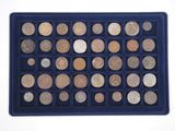 a blue tray filled with lots of different coins on top of a white surface