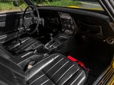 a yellow car with black leather seats and a steering wheel
