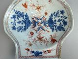 a blue and white plate with flowers and birds on it