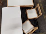 a white table and four chairs in a room