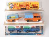 three toy trucks that are sitting on top of each other