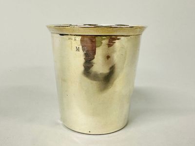 a silver cup that is sitting on a table