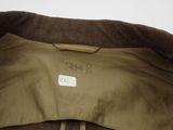 the back of a brown jacket with a label on it