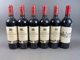 six bottles of wine are lined up in a row