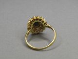 a close up of a gold ring with a stone in the center