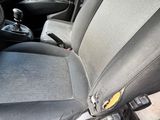 a seat in the back of a car with a yellow button on it