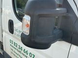 a white van that is parked on the side of the road