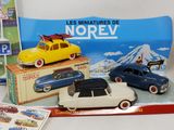 several toy cars are sitting on a table next to a box