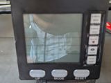 a small monitor sitting on top of a luggage bag