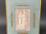 an old picture frame with a picture of a woman holding a child