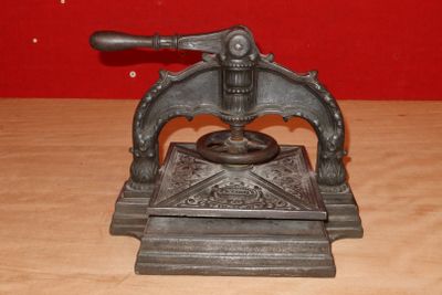 an old cast iron pepper mill on a wooden table