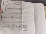 someone is holding a piece of paper with drawings on it