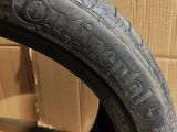 a close up of a tire on a cardboard box with a cardboard box in the background