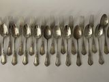 a lot of silver spoons and forks on the table