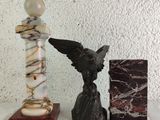 a statue of an angel and a book on a table